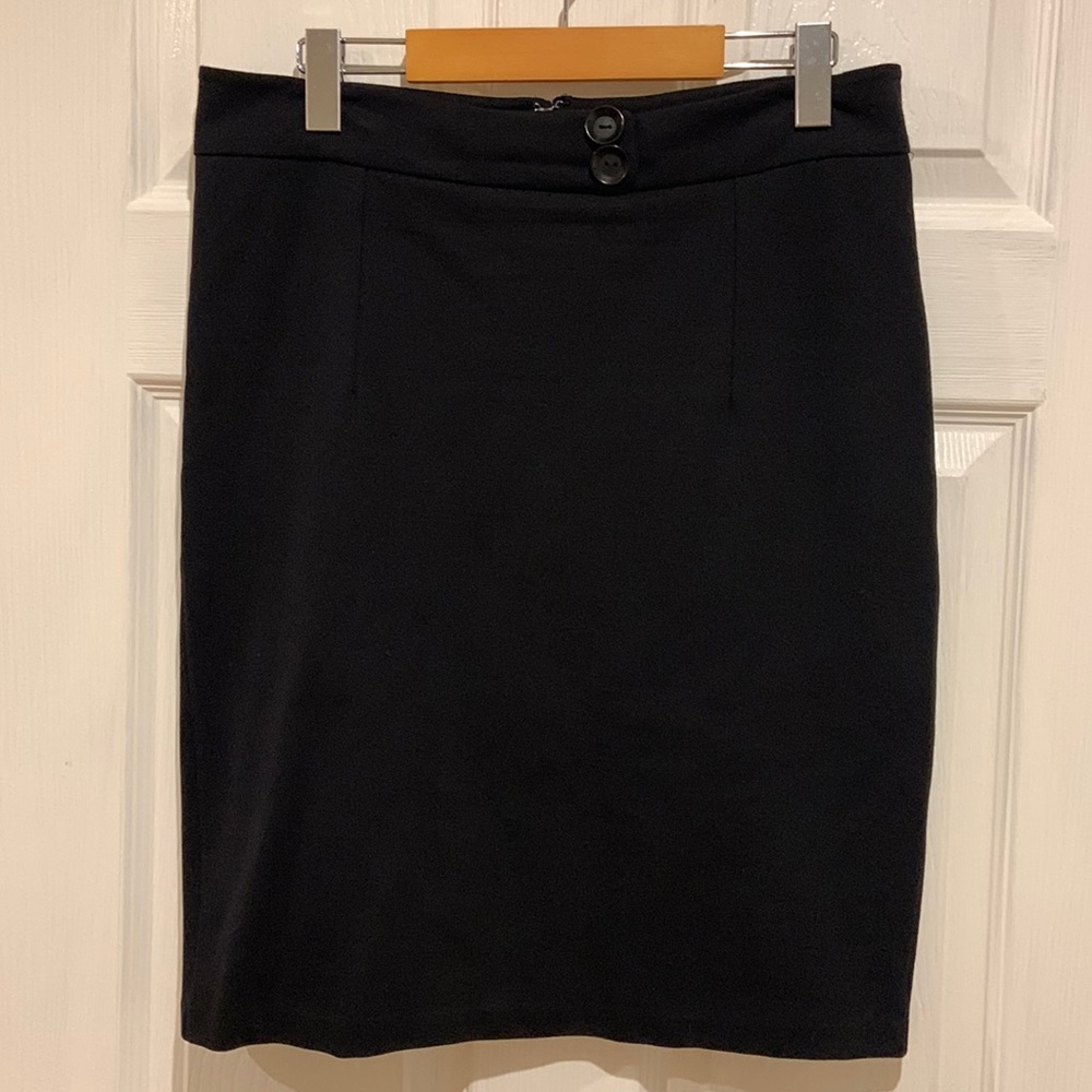Black pencil skirt with button decoration at waist. Back zip. Mint condition